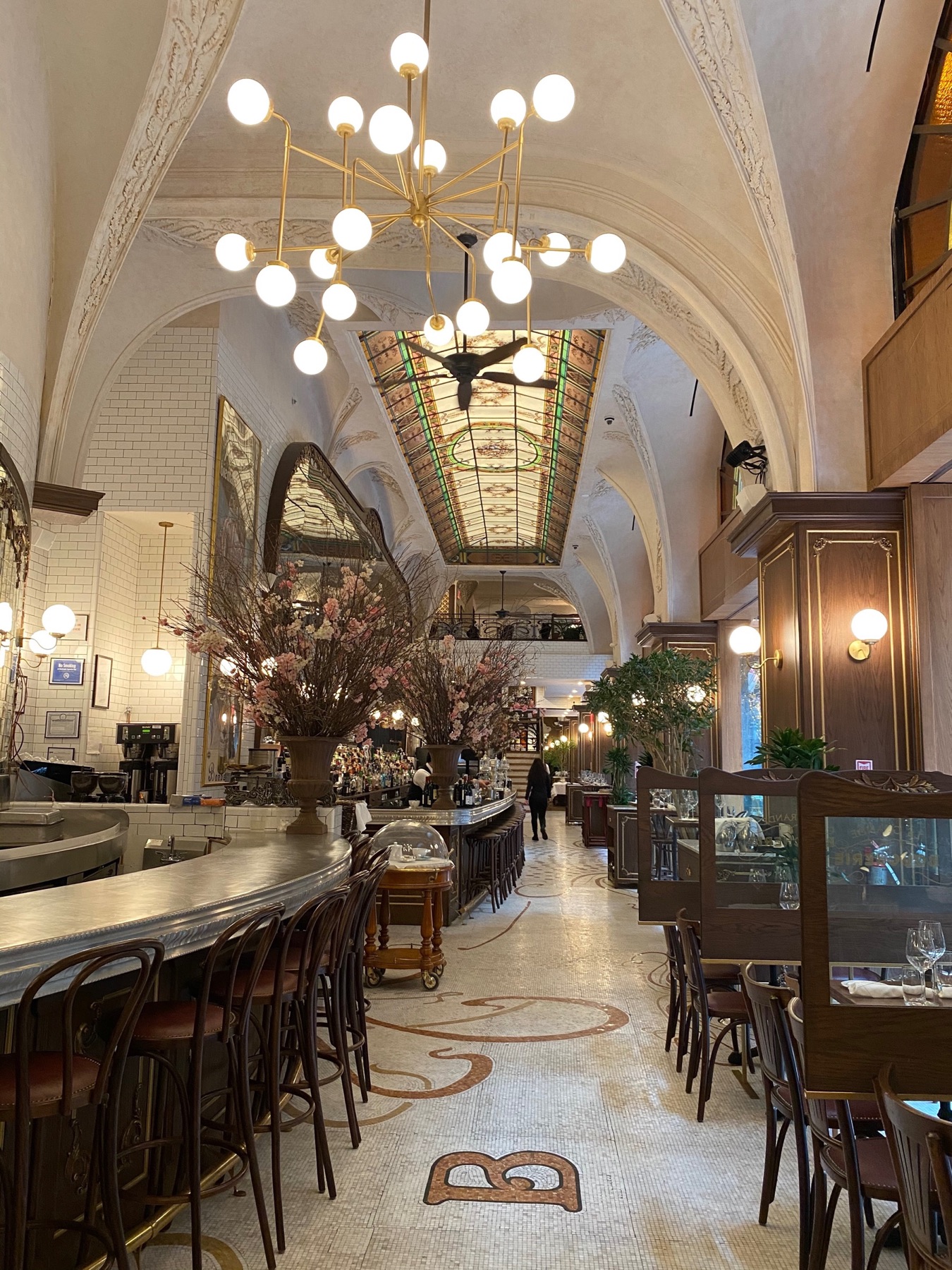 A grand New York dining room with ornate arches and globe lights